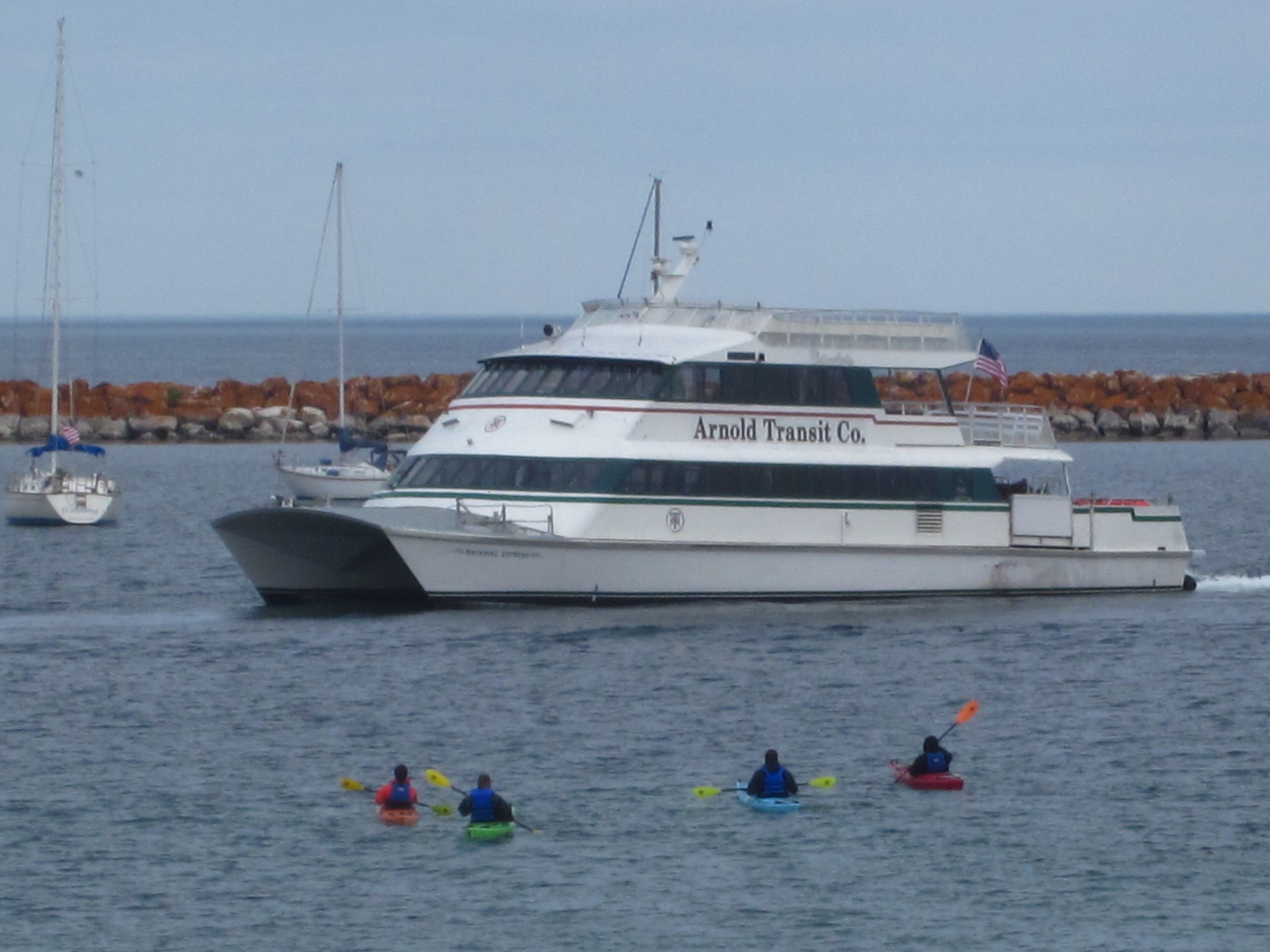 Kayak tour watches and waits for the Arnold Line catamaran to dock